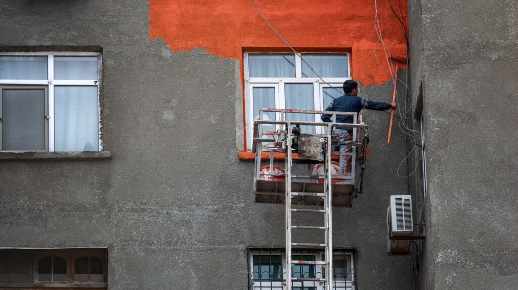 Worker paints the wall of a residential house